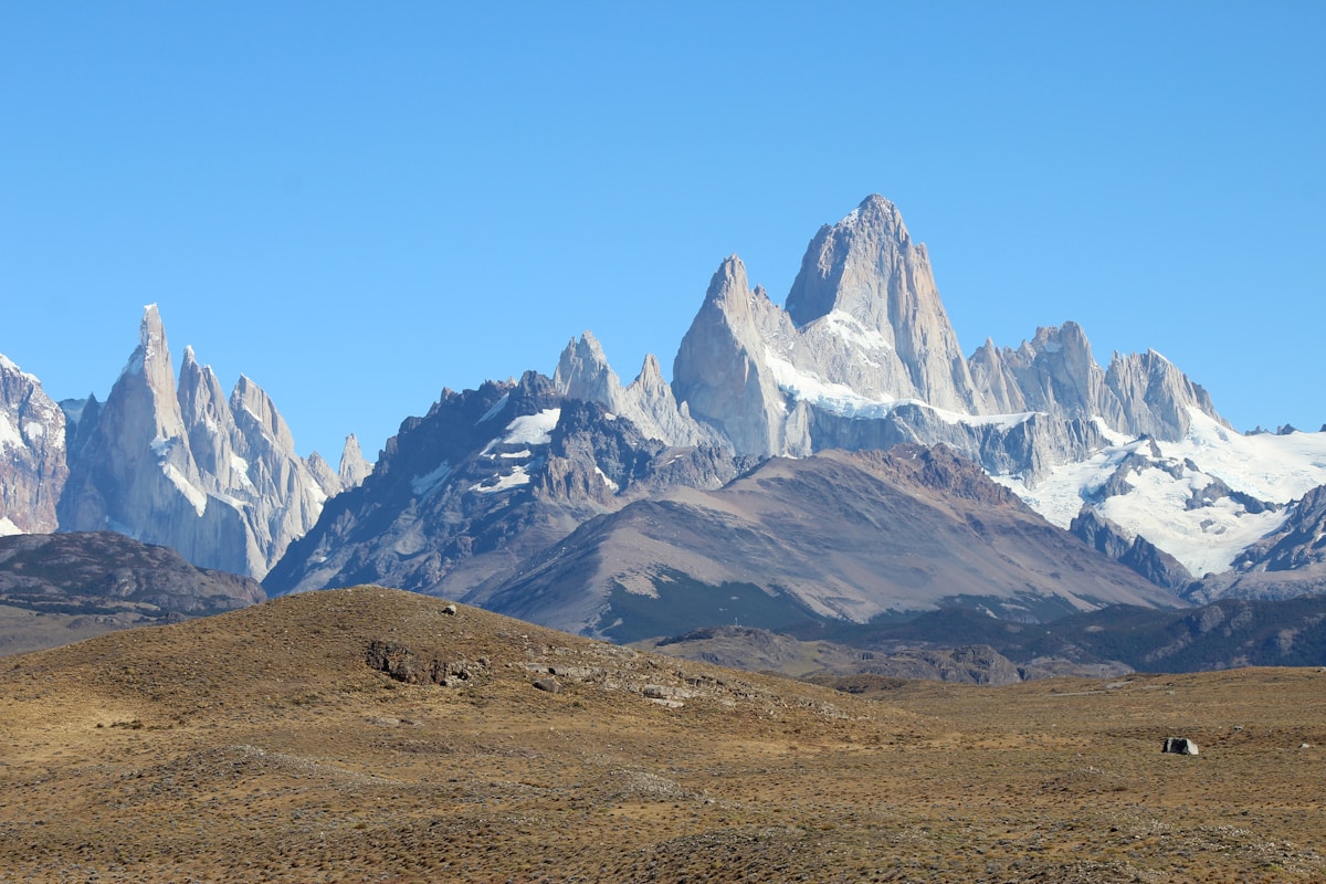 The granite towers of Fitz Roy rising above clouds at dawn, El Chaltén, Patagonia