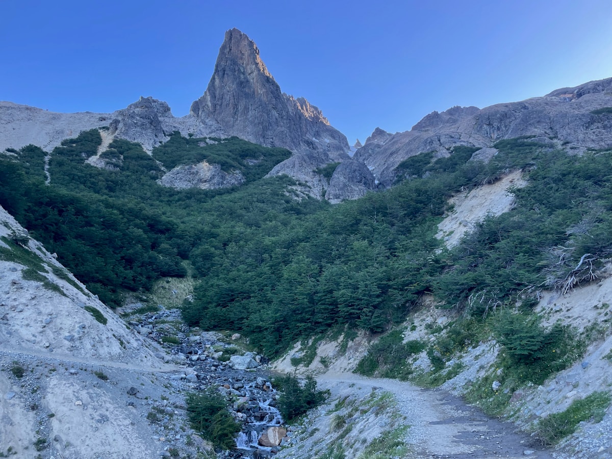 Jagged mountain peak rising above a green trekking valley, Bariloche, Río Negro, Argentina