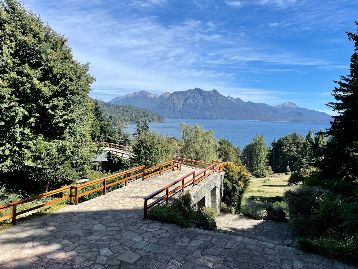 Stone walkway leading to Lake Nahuel Huapi with mountains, Bariloche, Argentina