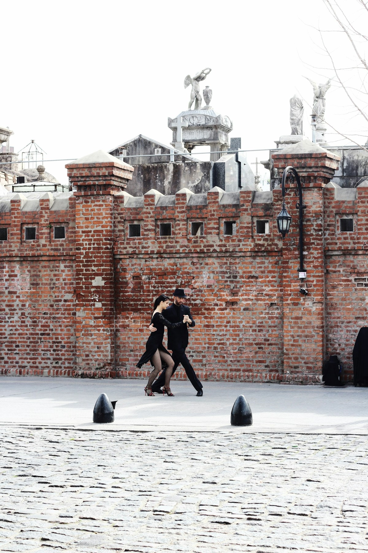 Couple dancing tango on cobblestone square, Recoleta, Buenos Aires, Argentina