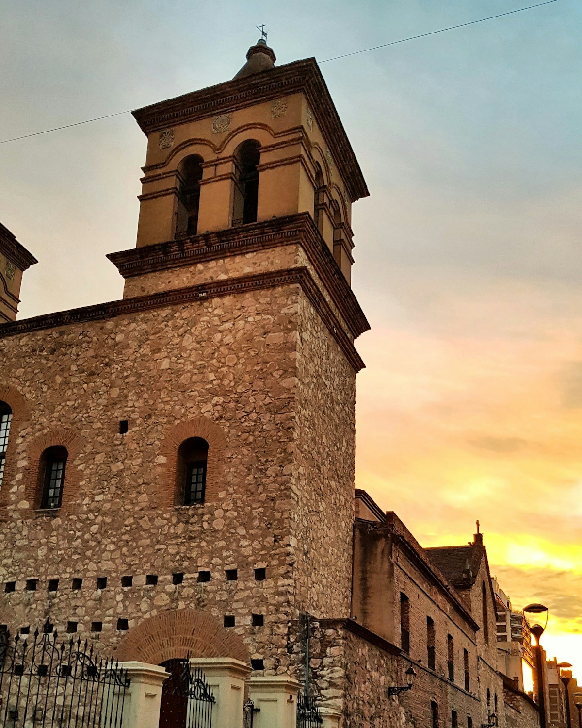 Historic stone church tower of the Jesuit Block at sunset, Córdoba city centre, Argentina