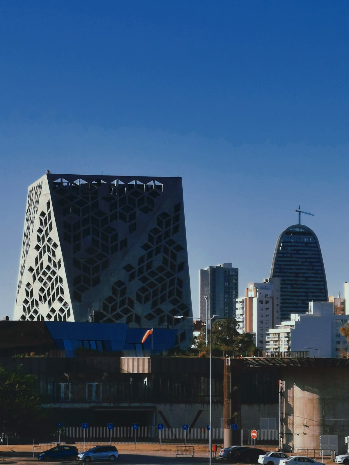 Córdoba modern city skyline with geometric architecture and high-rise towers under blue sky, Argentina