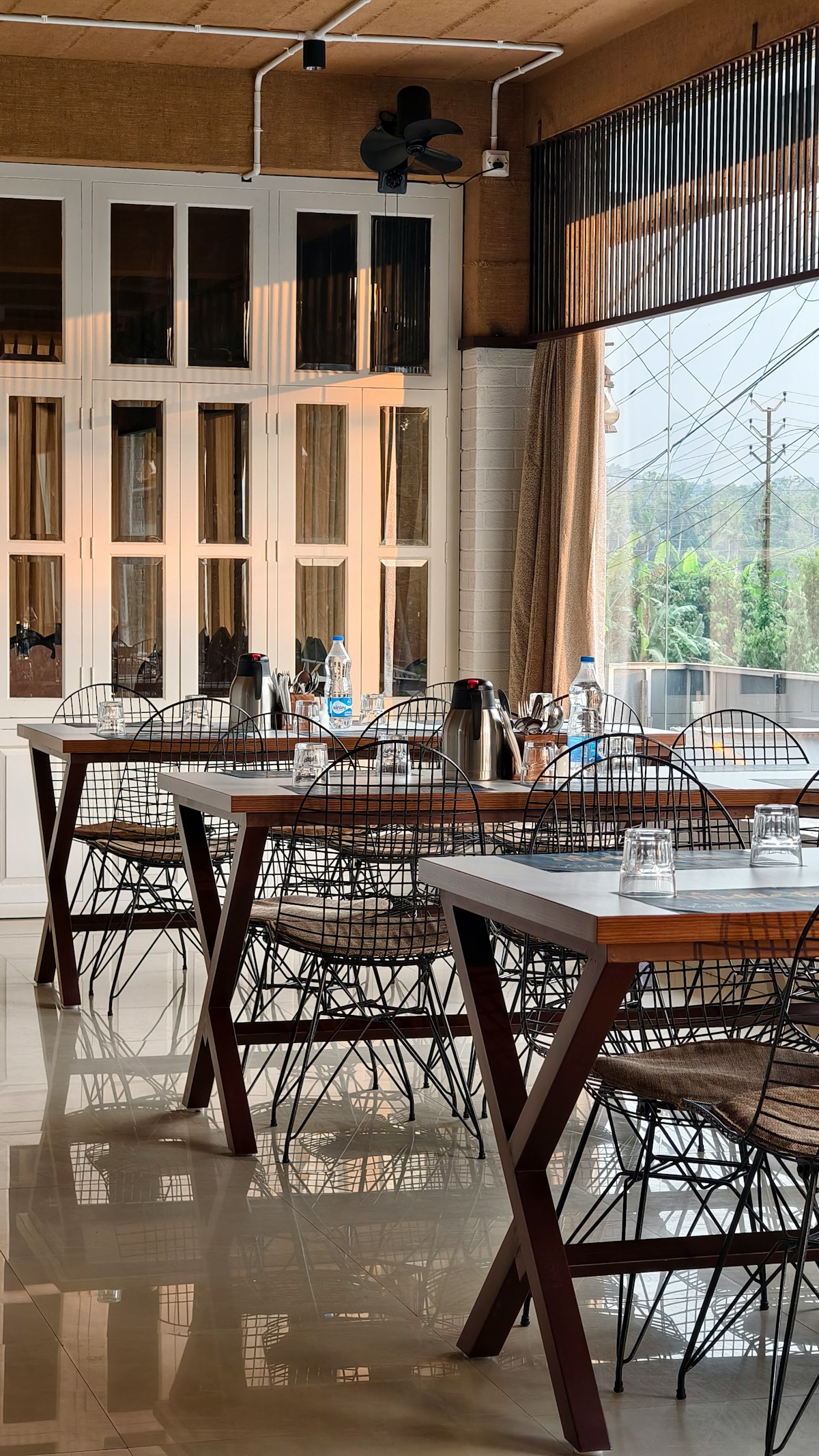 Restaurant dining room with wooden tables and wire chairs, contemporary interior, Argentina