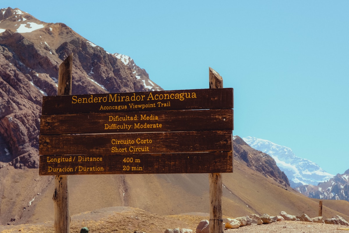Aconcagua viewpoint trail sign with Andes peaks behind, Mendoza, Argentina