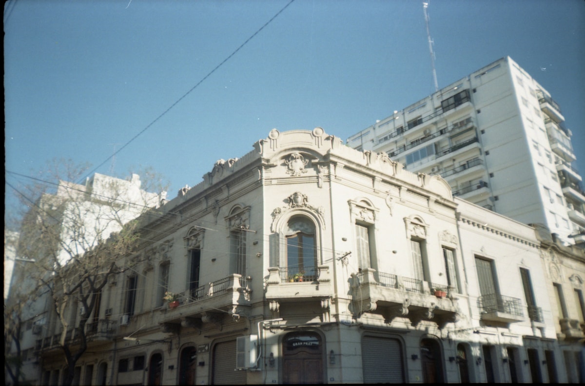 Belle Époque ornate building facade on a sunlit street in Rosario, Argentina