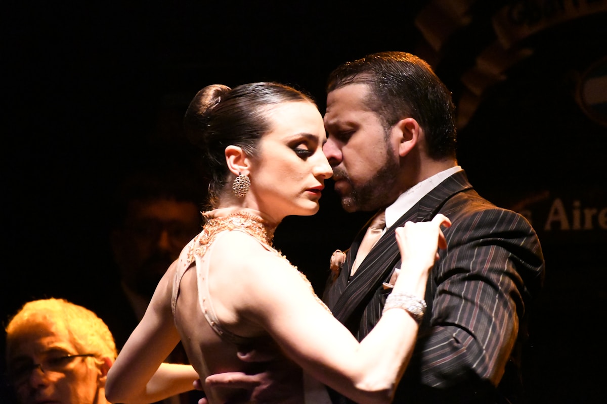 Tango dancers performing in Buenos Aires with a live orchestra in the background