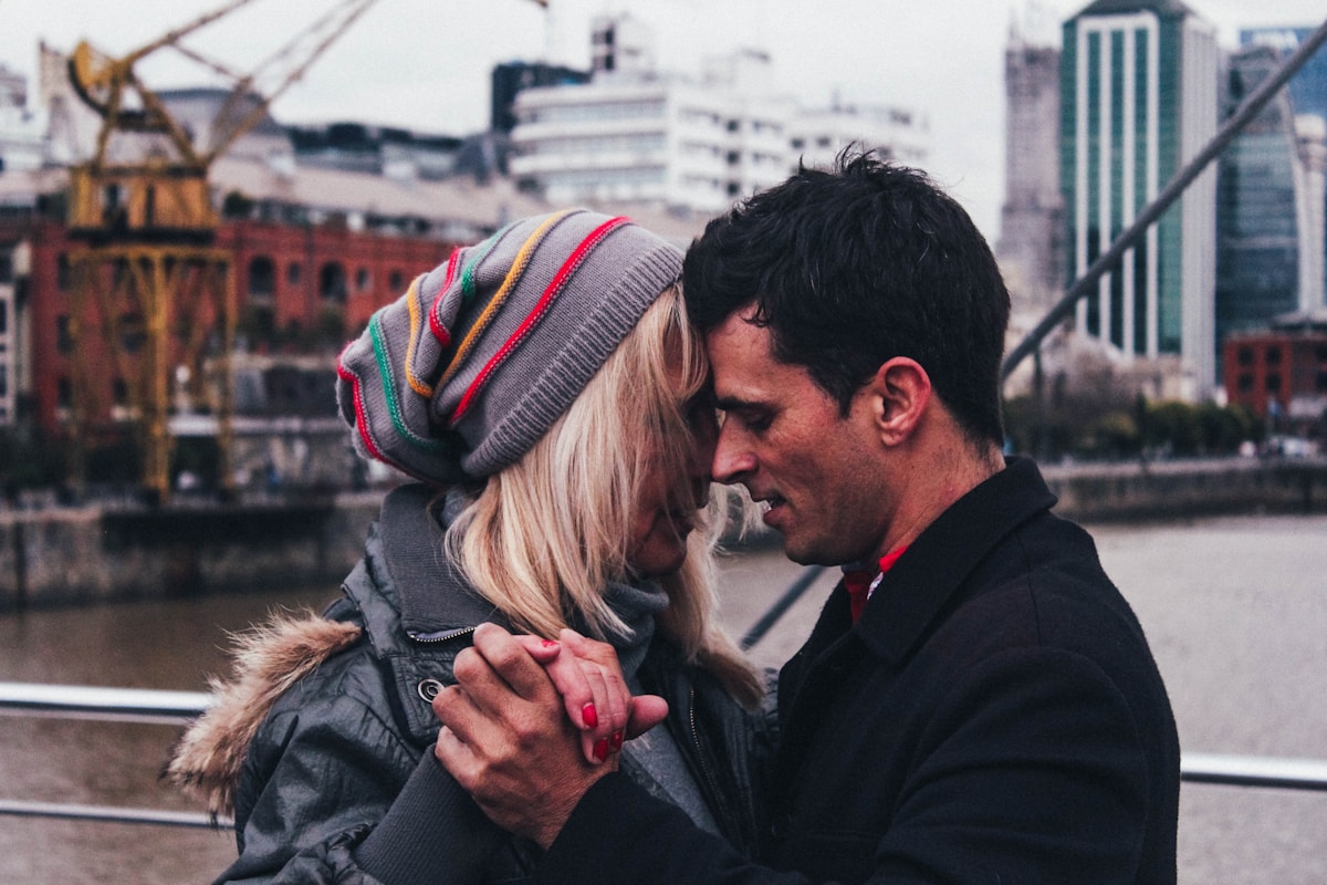 Couple sharing a romantic moment at Puente de la Mujer, Puerto Madero, Buenos Aires, Argentina