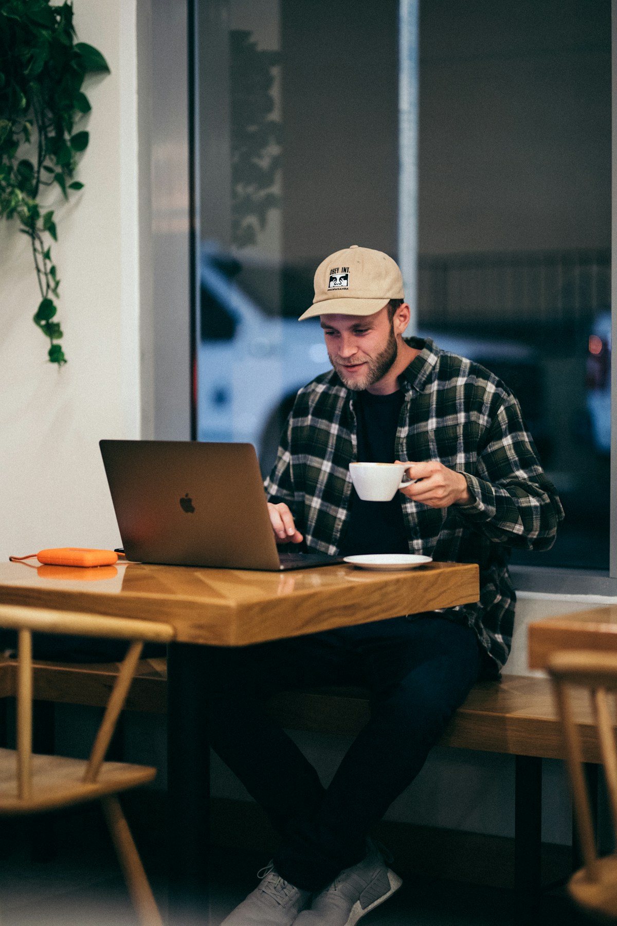 Man working on laptop with coffee at a Mendoza cafe, Argentina
