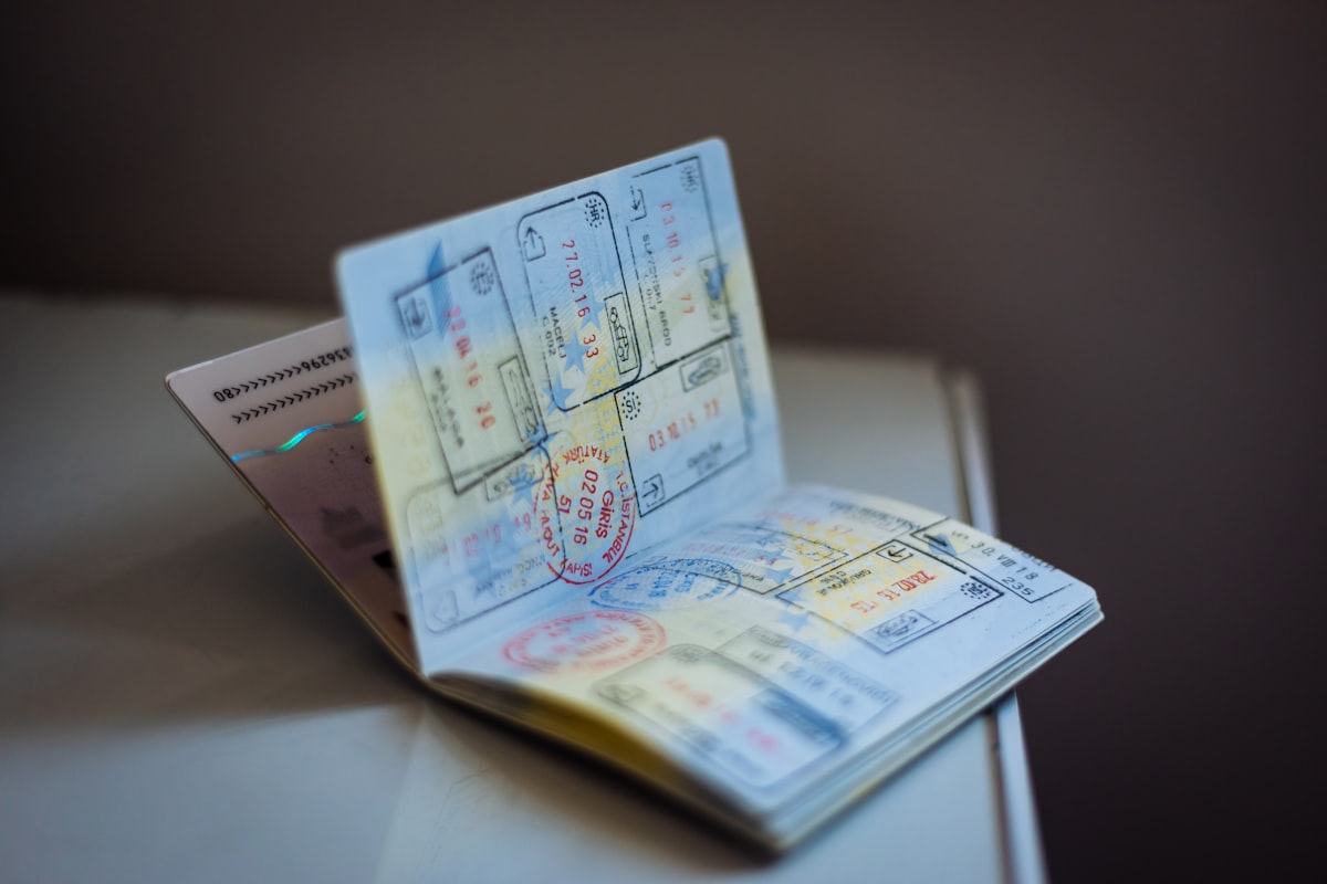 Open passport with multiple colourful entry stamps and visa pages visible