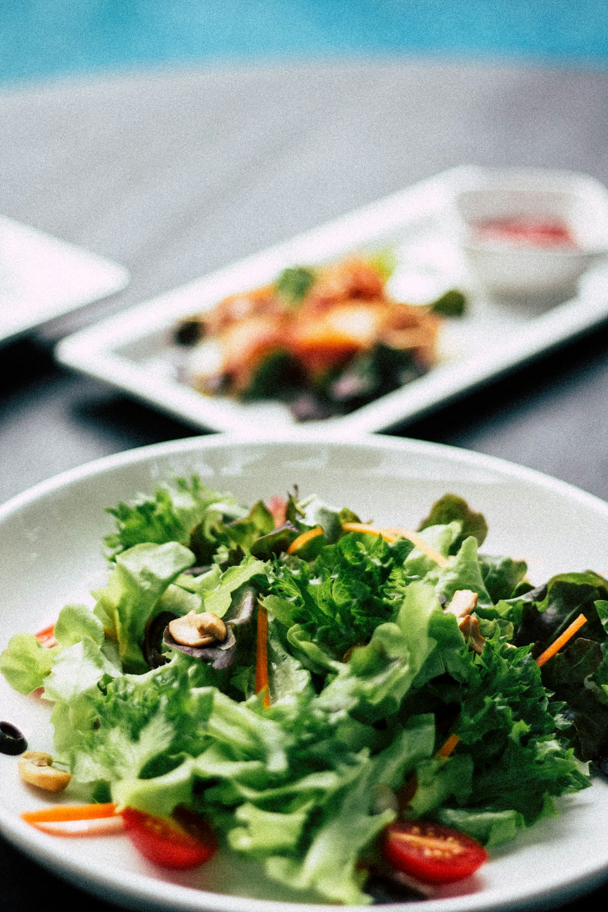 Green salad with cherry tomatoes on a white plate
